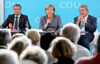 Angela Merkel zwischen Landesgeneralsekretär Vincent Kokert (l) und Lorenz Caffier, Spitzenkandidat zur Landtagswahl.