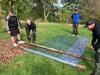 Using a tarpaulin and thin tree trunks, you can quickly roll up a stretcher for the injured.